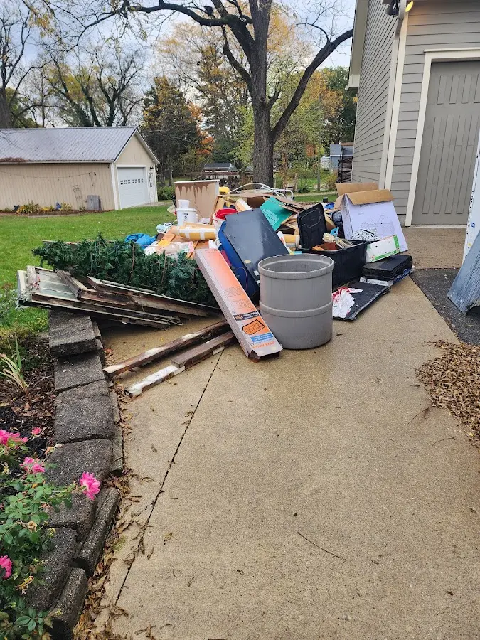 Dumpster being loaded with debris for Estate Cleanout Dumpster Rental in North Vernon